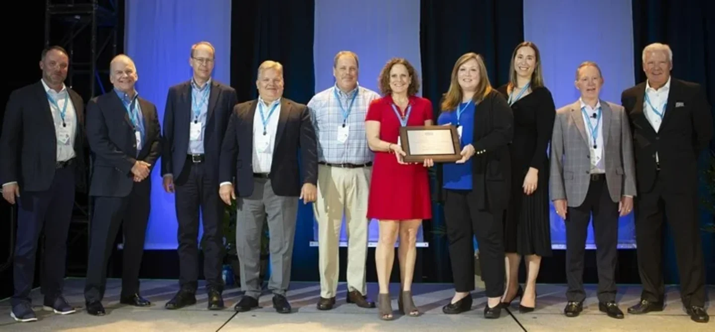 Huber Advanced Materials News EHSS Award People stand on a stage and get a certification